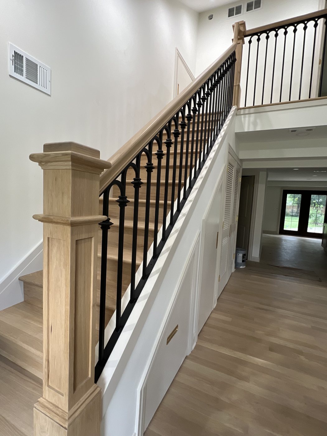 Custom interior iron railing on wood staircase